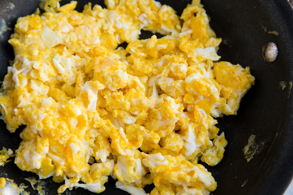 Scramble the eggs in a separate skillet