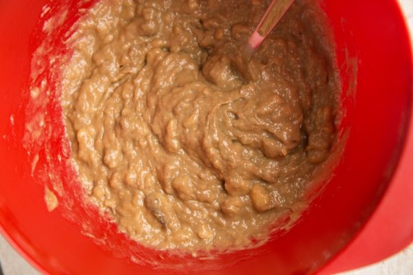 Mashed banana and almond butter mixed together in a mixing bowl