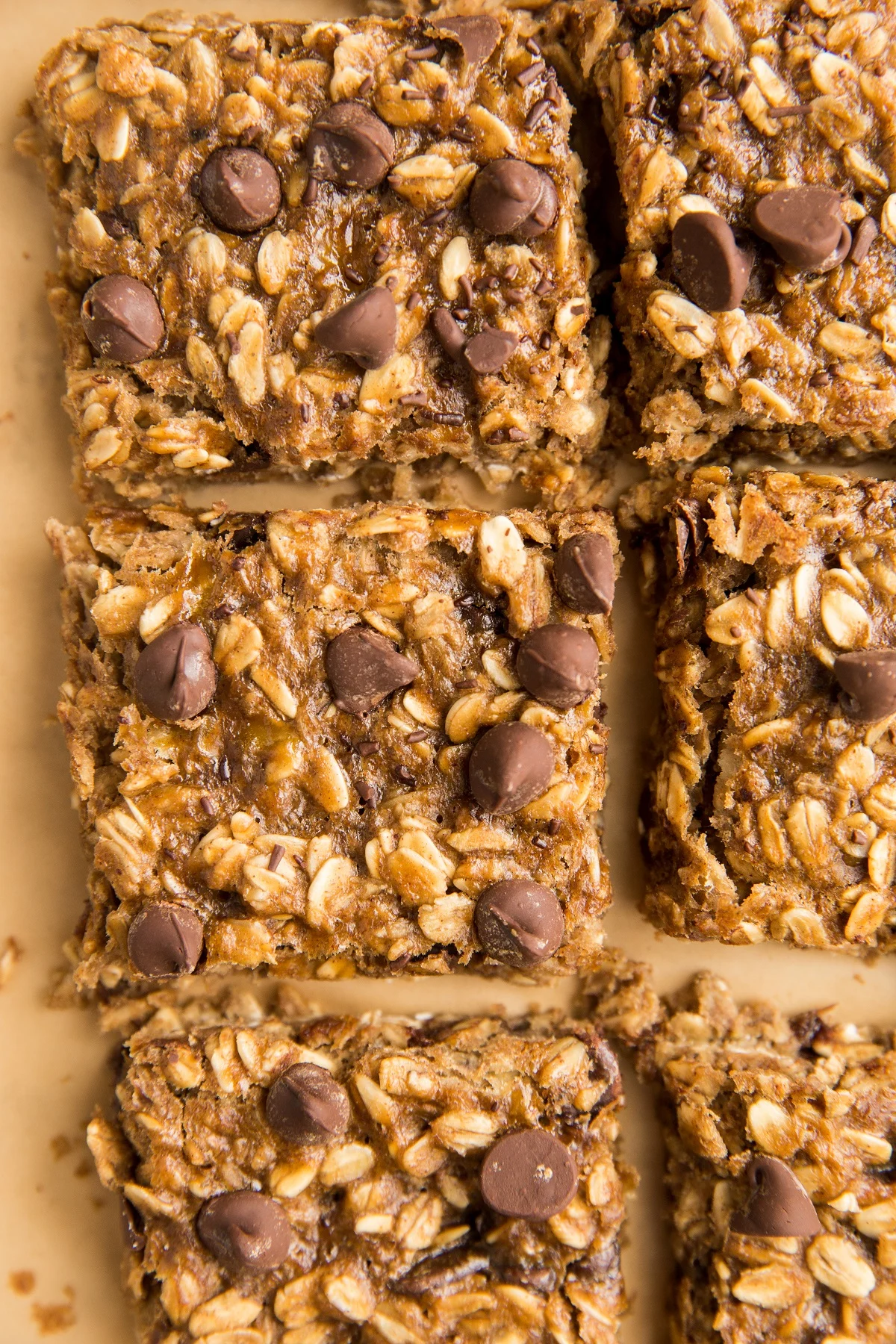 Slices of Oatmeal Bars on a sheet of parchment paper, ready to eat.