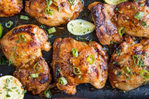 Baked chicken thighs in a casserole dish. Golden-brown crispy thighs