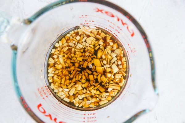 Marinade ingredients for chicken thighs in a measuring cup