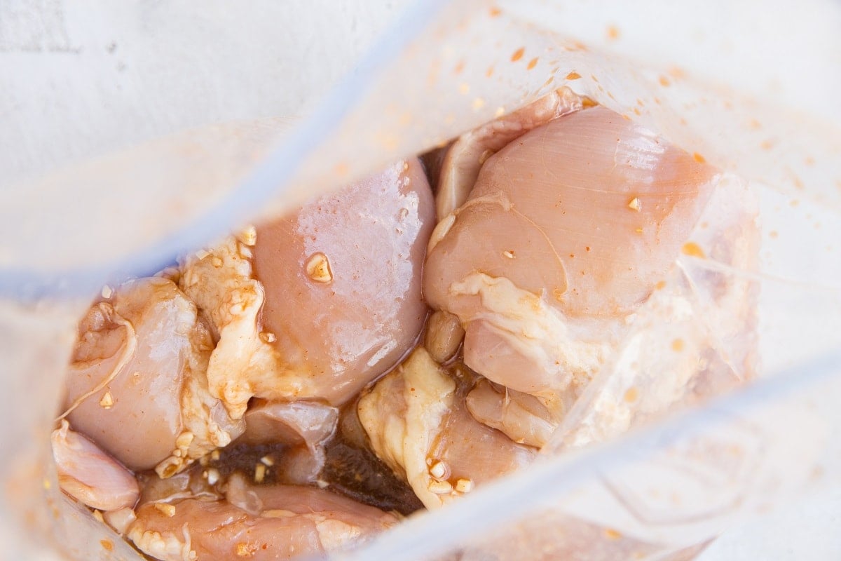 Chicken thighs and marinade in a zip lock bag.