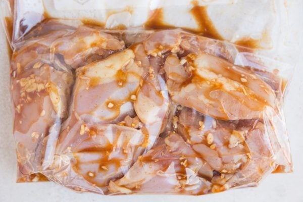 Chicken sealed in a zip lock bag in marinade