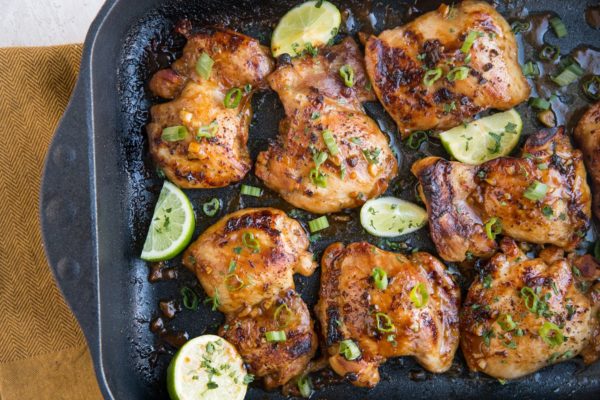 Finished baked chicken thighs in a casserole dish all golden brown and delicious