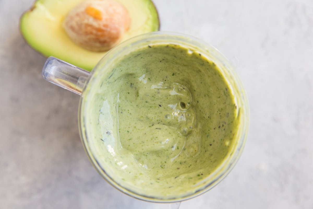 Blended avocado smoothie in a blender.