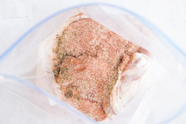 Chicken and seasoning in a zip lock bag