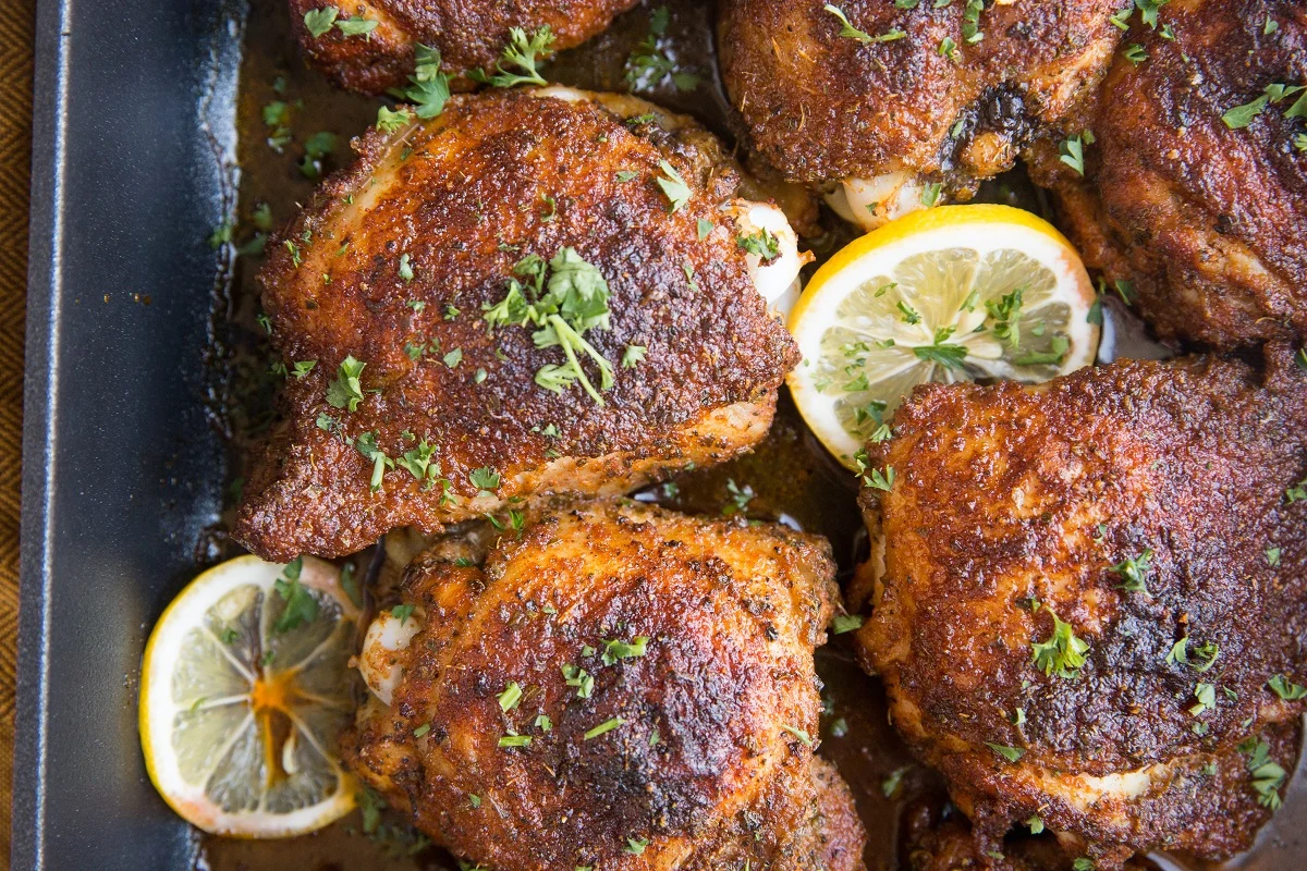 horizontal top down photo of blackened chicken in a baking dish