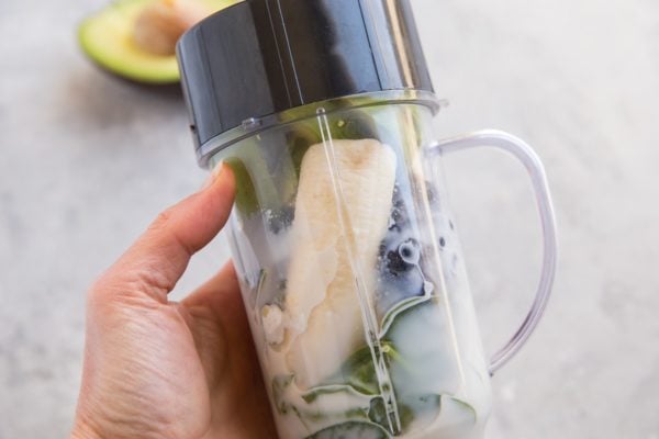 Small blender with smoothie ingredients inside, ready to be blended