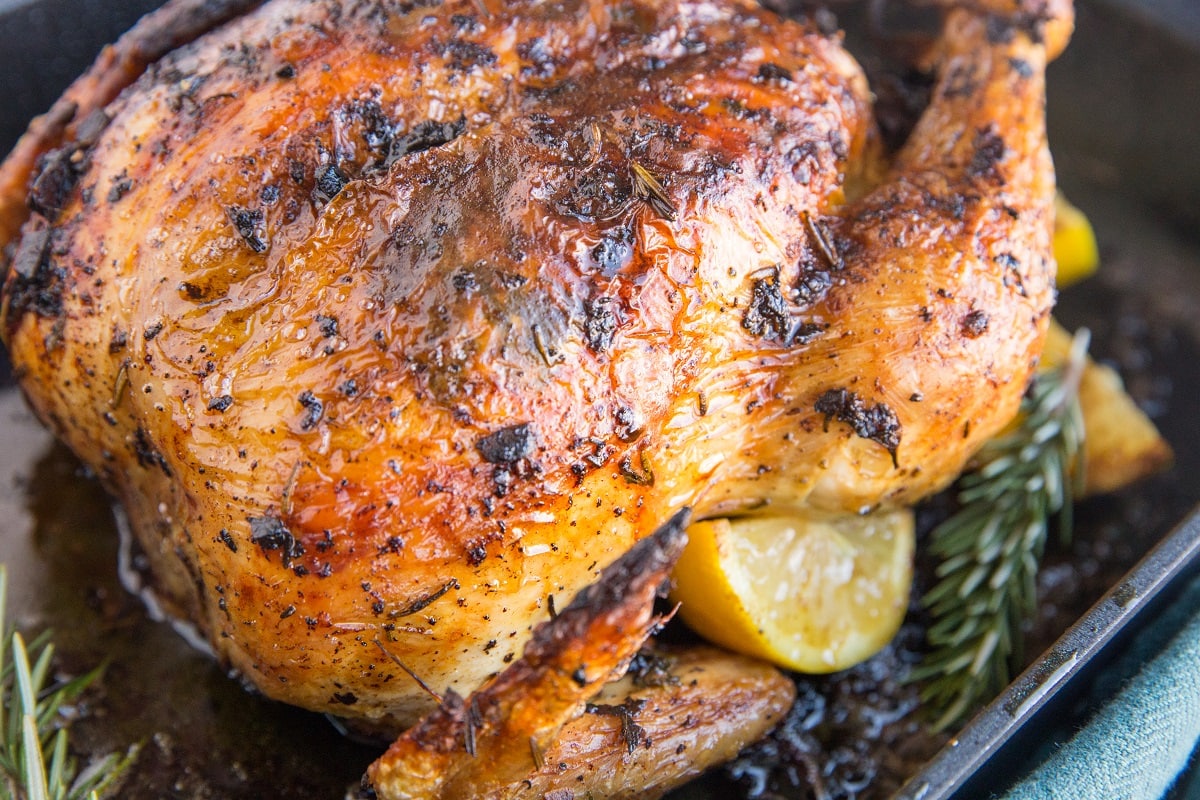 horizontal photo of finished garlic butter roast chicken fresh out of the oven