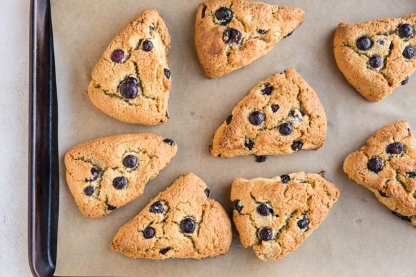 Finished blueberry almond flour scones on a baking sheet fresh out of the oven