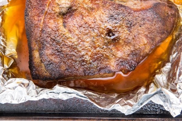 Roast brisket that is fully cooked sitting in foil