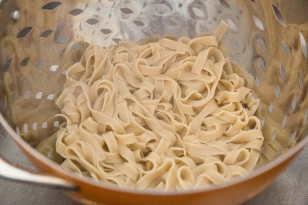 Cooked gluten-free noodles in a collander