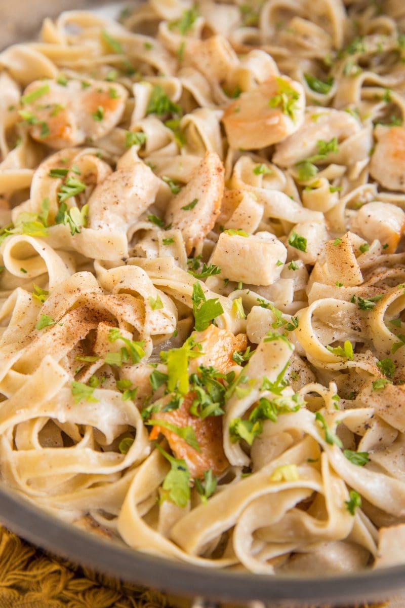 Stainless steel skillet of chicken alfredo.