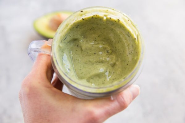 Hand holding a glass of smoothie