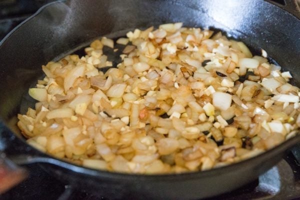 Onion and garlic sautéing in cast iron skillet