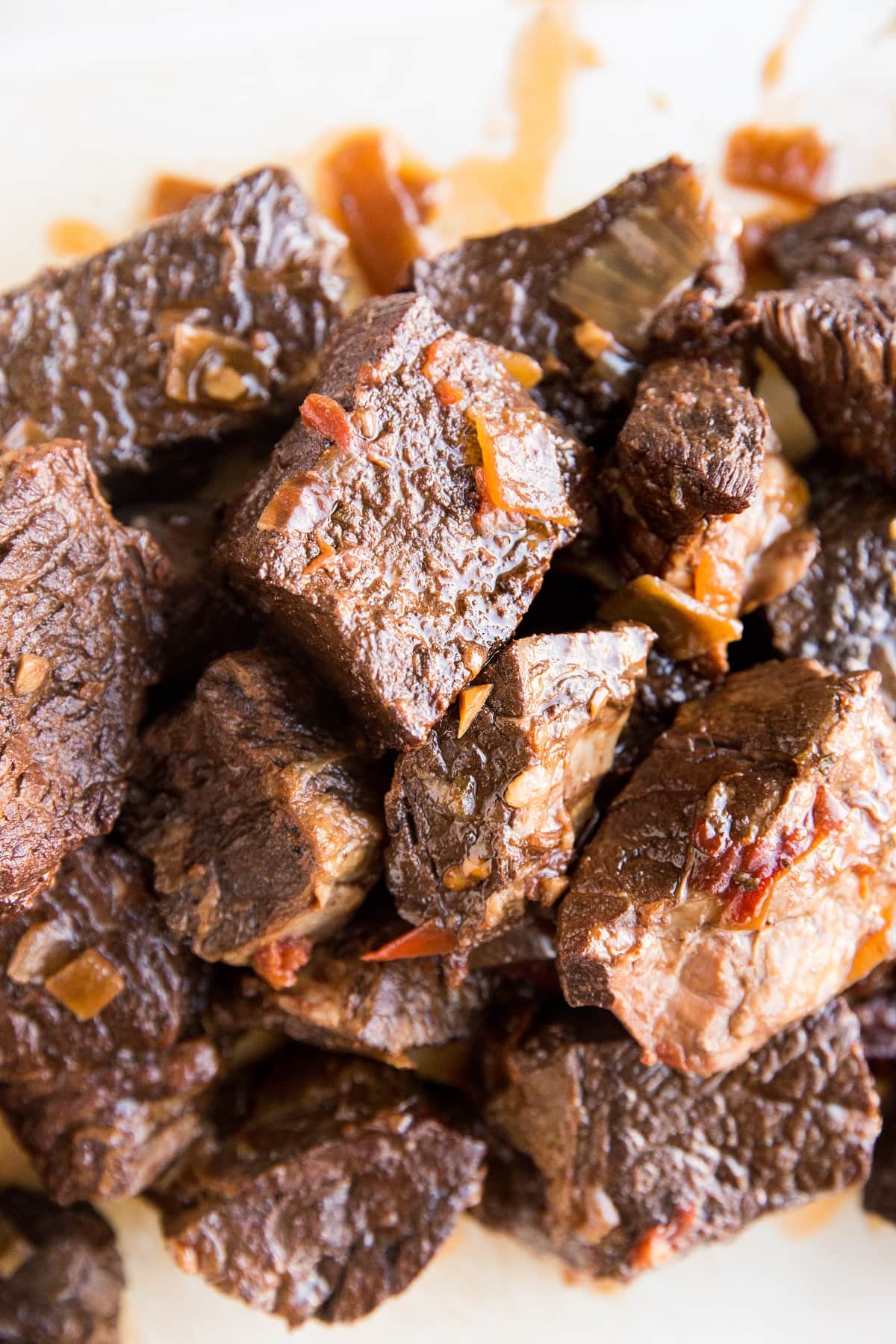 Beef for birria tacos on a cutting board ready to be shredded