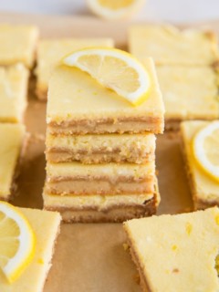 Stack of keto lemon bars with slice of lemon on top