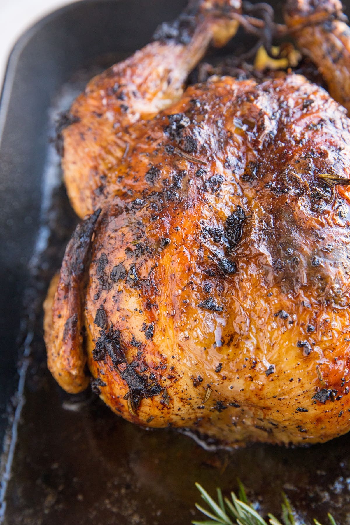 Finished roasted garlic herb butter chicken in a roasting pan