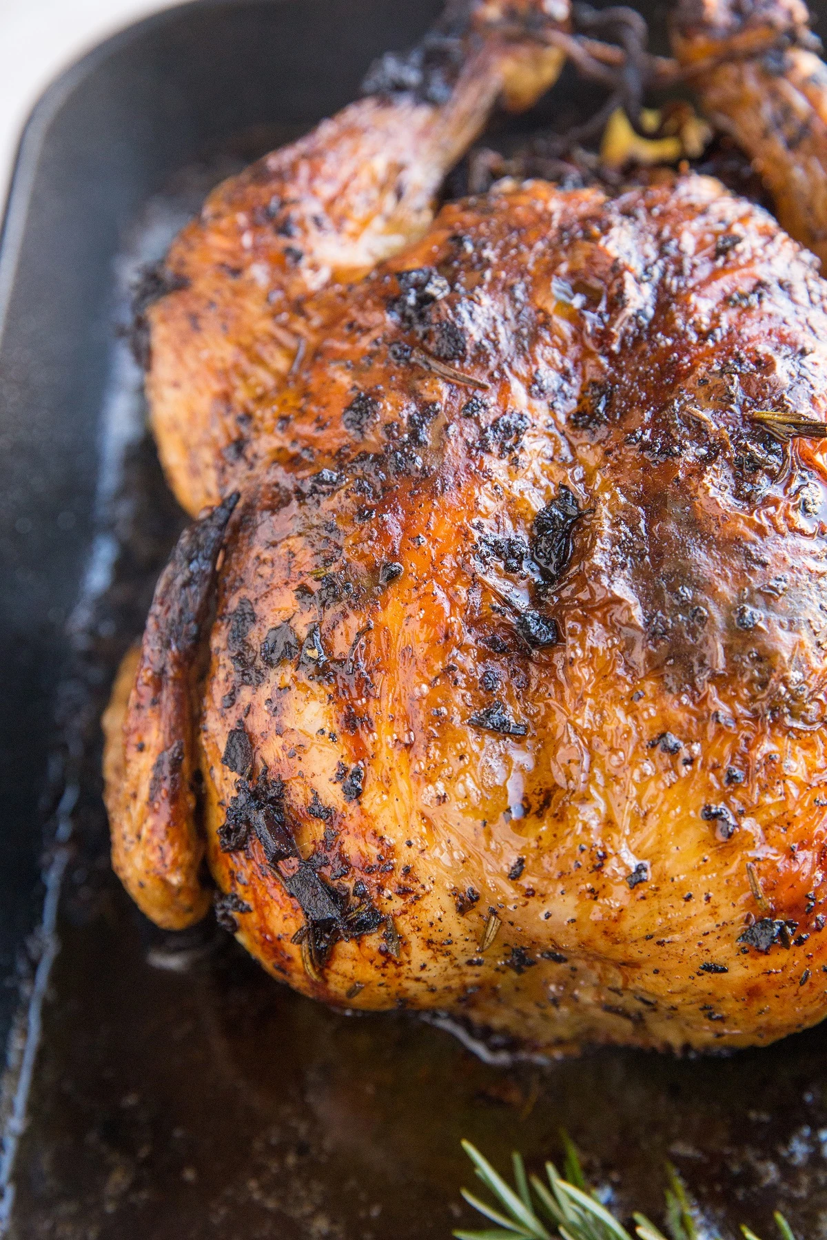 Finished roasted garlic herb butter chicken in a roasting pan