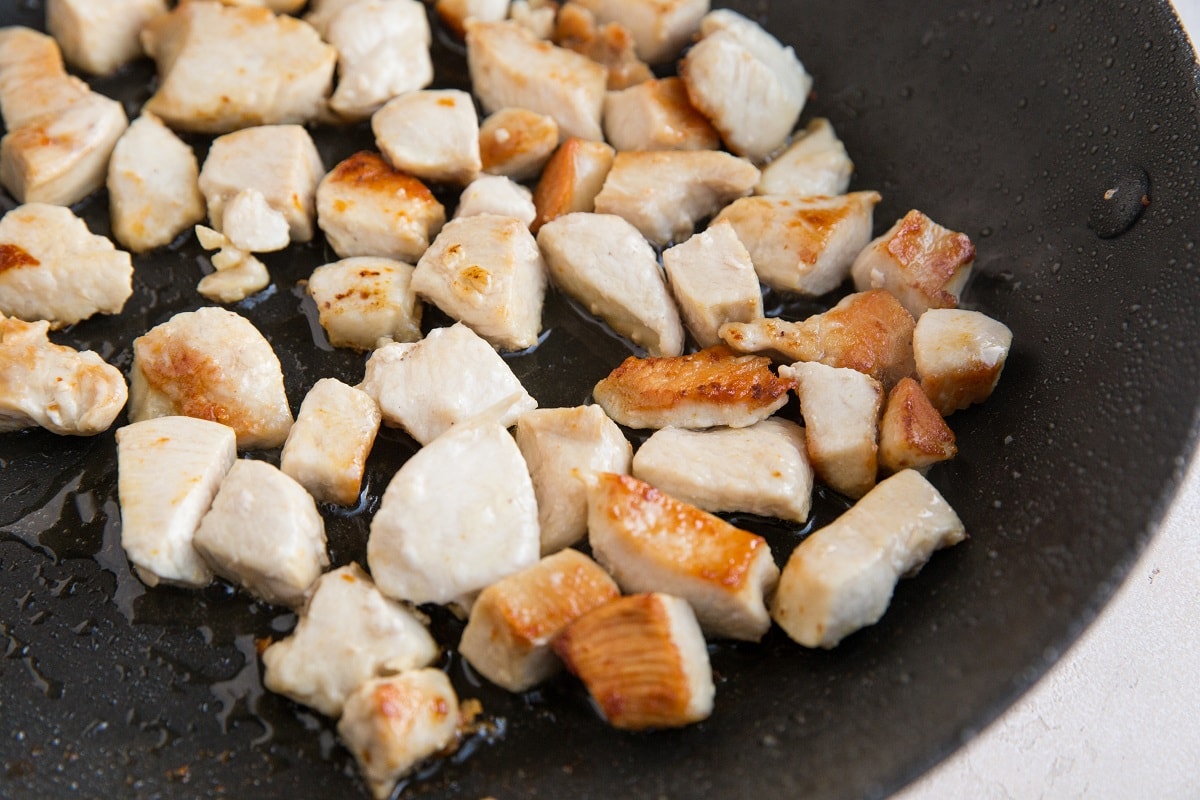 Chicken browning in a skillet