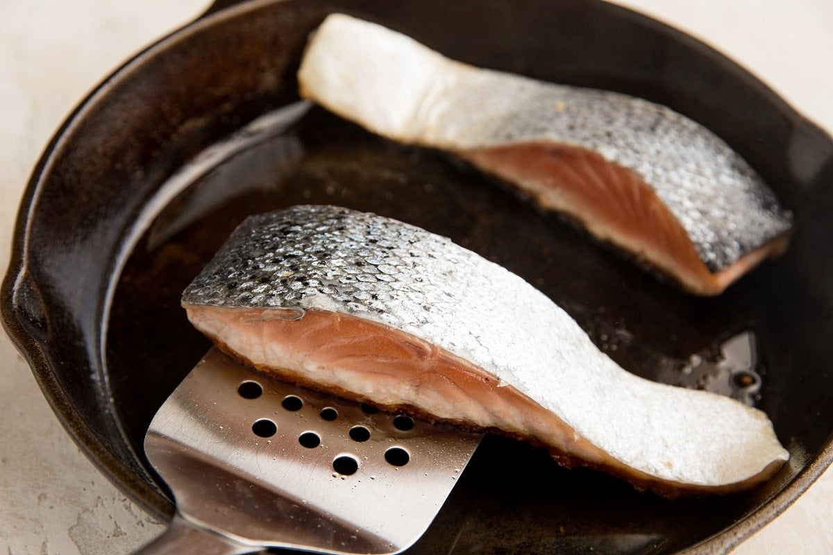 Spatula underneath salmon getting ready to flip it