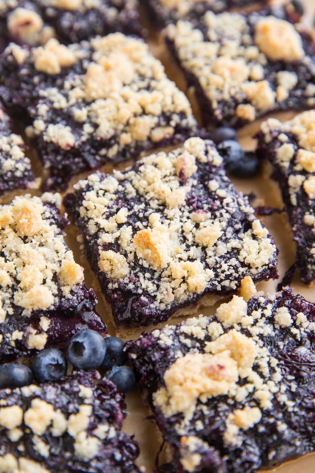 Low-Carb Blueberry Crumb Bars cut into slices on a sheet of brown parchment paper