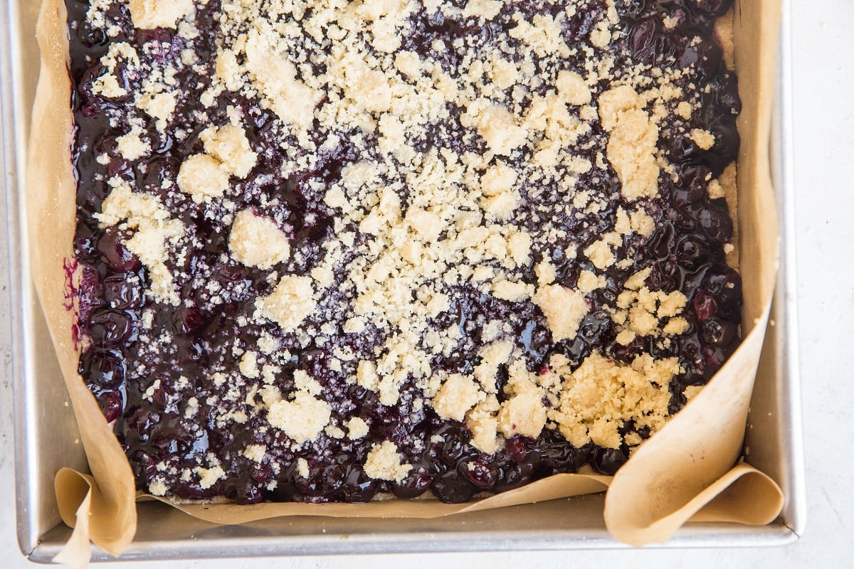Blueberry crumble bars fresh out of the oven in a cake pan