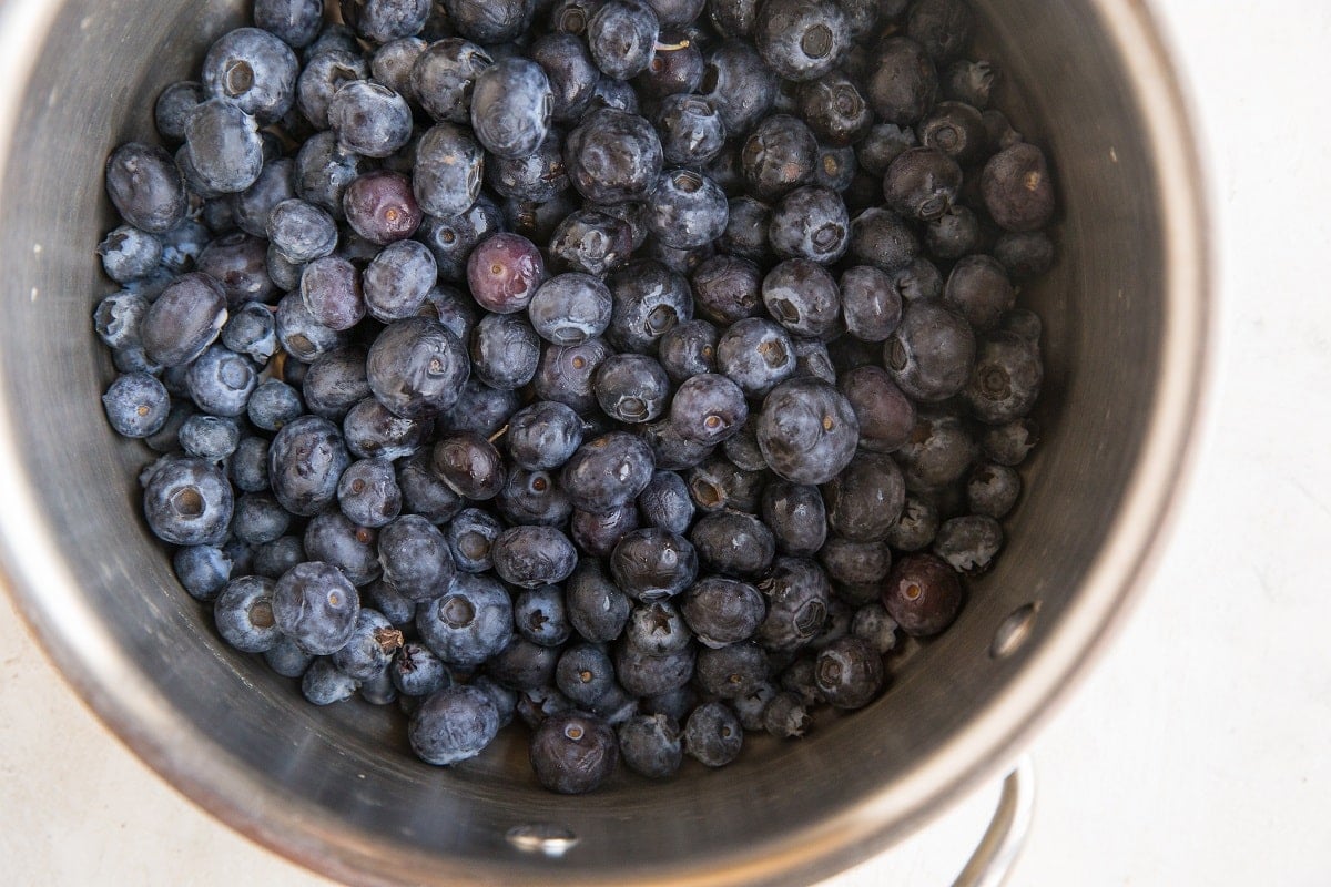 Blueberries inside a medium saucepan ready to turn into filling
