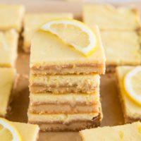 Stack of keto lemon bars with slice of lemon on top