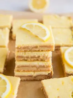 Stack of keto lemon bars with slice of lemon on top