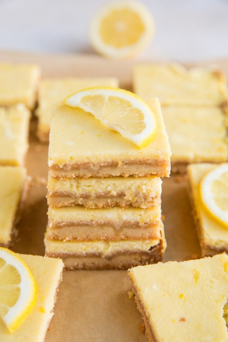 Stack of keto lemon bars with slice of lemon on top