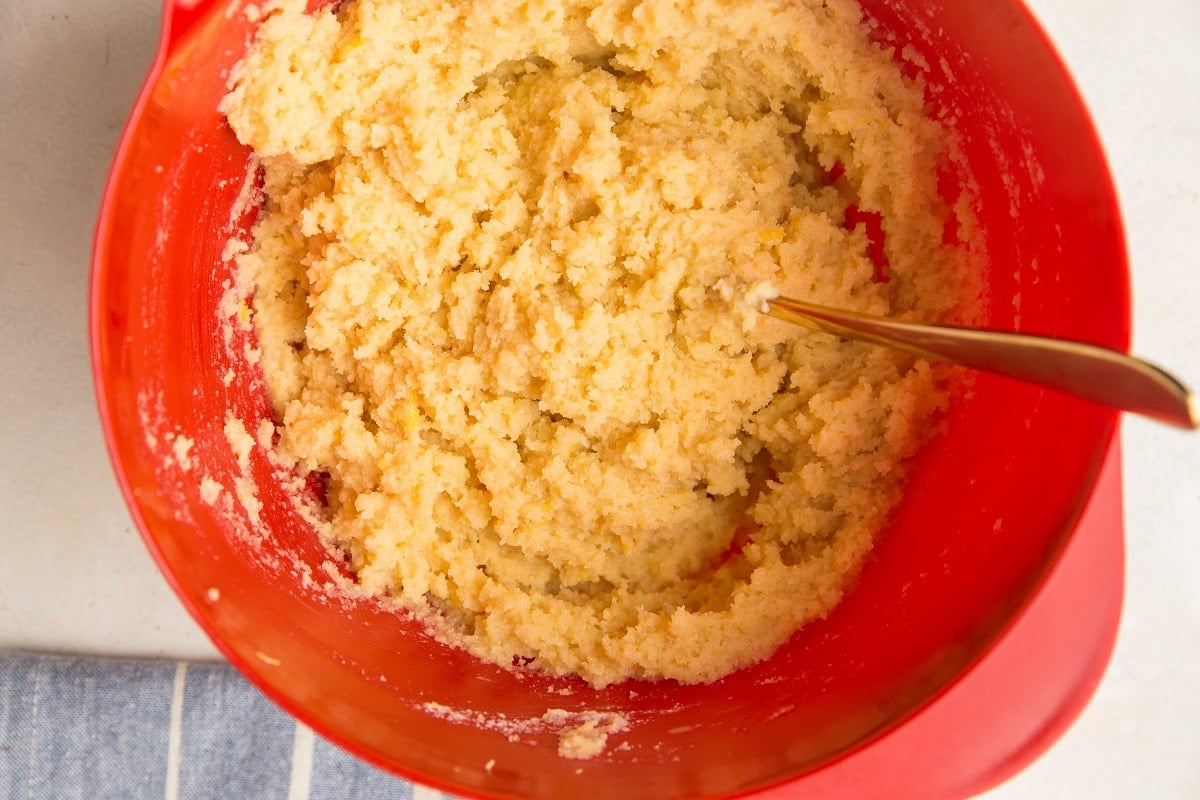 Pound cake batter with lemon zest in a mixing bowl