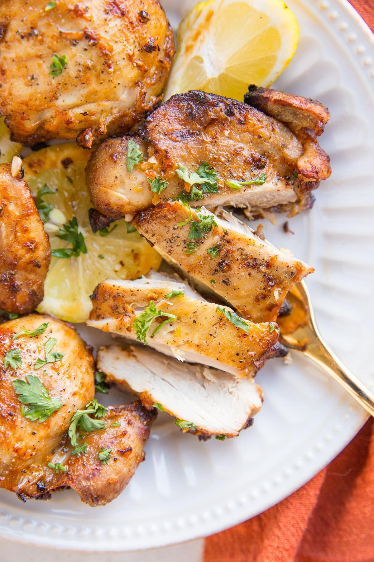 Chicken thigh cut into several pieces on a plate