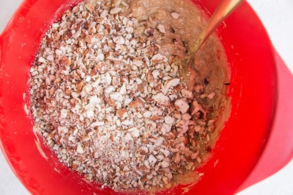 Mixing bowl with mashed bananas, almond butter and chopped nuts