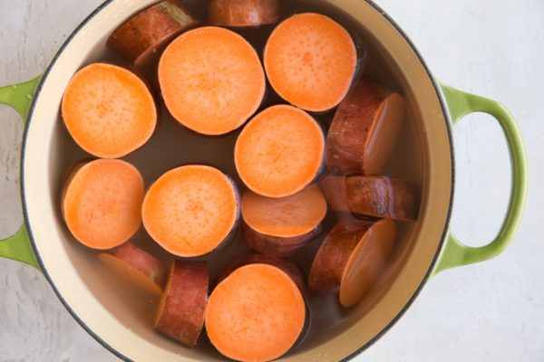 Sweet potato chunks being boiled in a pot of water