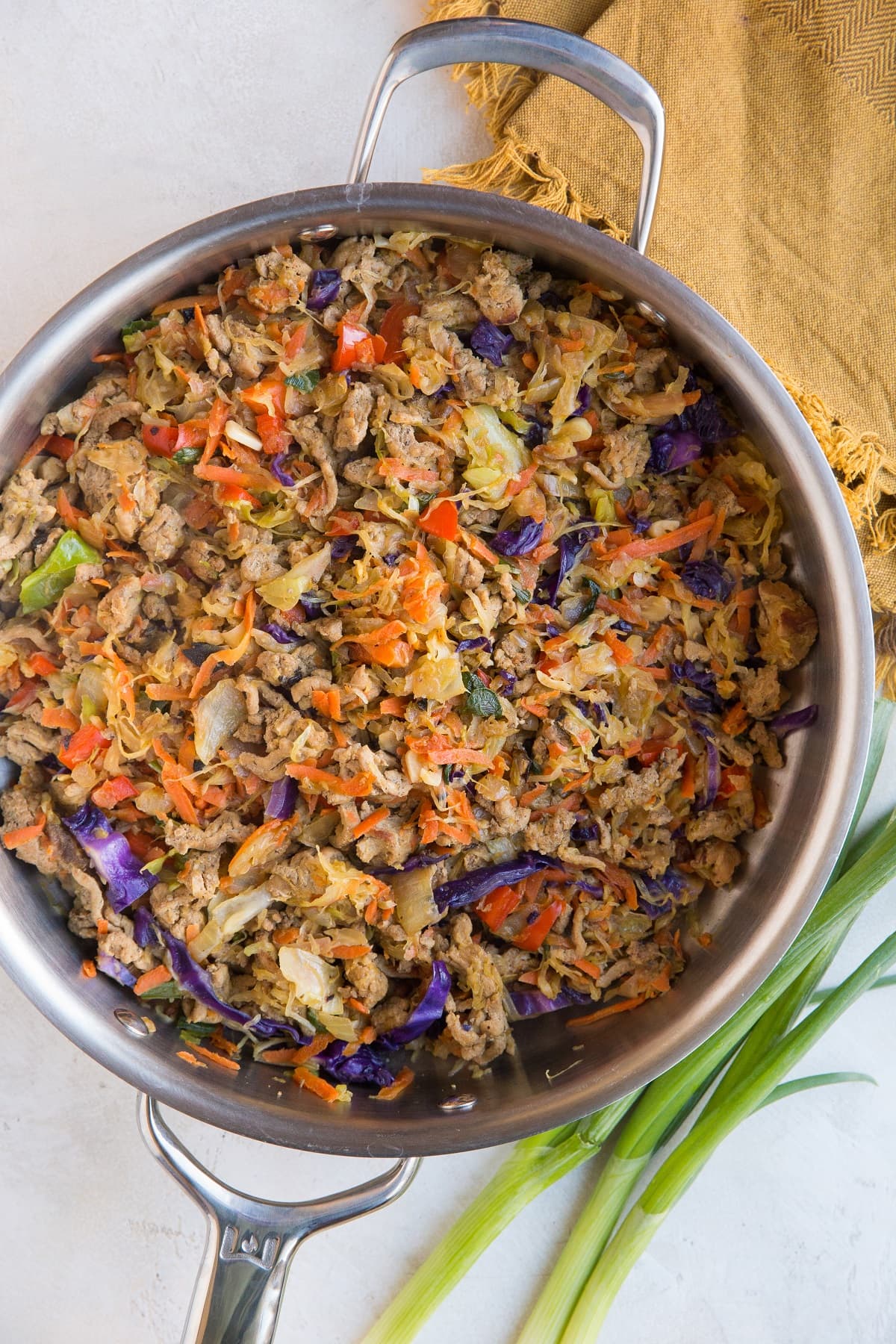 Stainless steel skillet with ground turkey and veggies in it for Thai turkey bowls