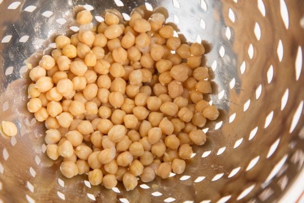 colander with chickpeas in it