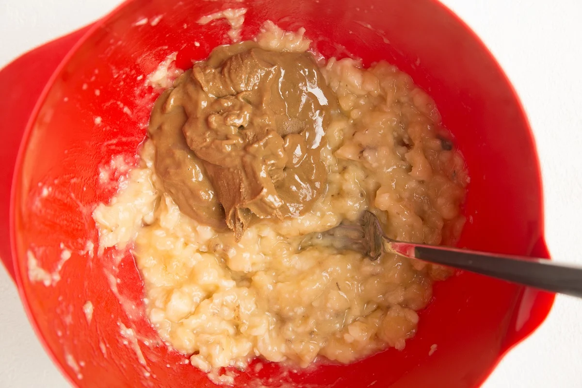 mashed banana and almond butter in a mixing bowl