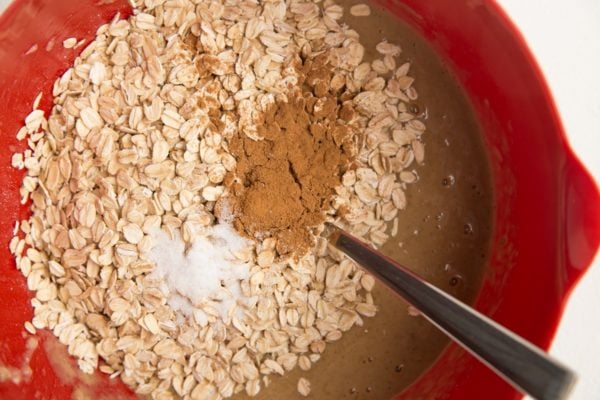 oats on top of wet mixture with cinnamon and salt