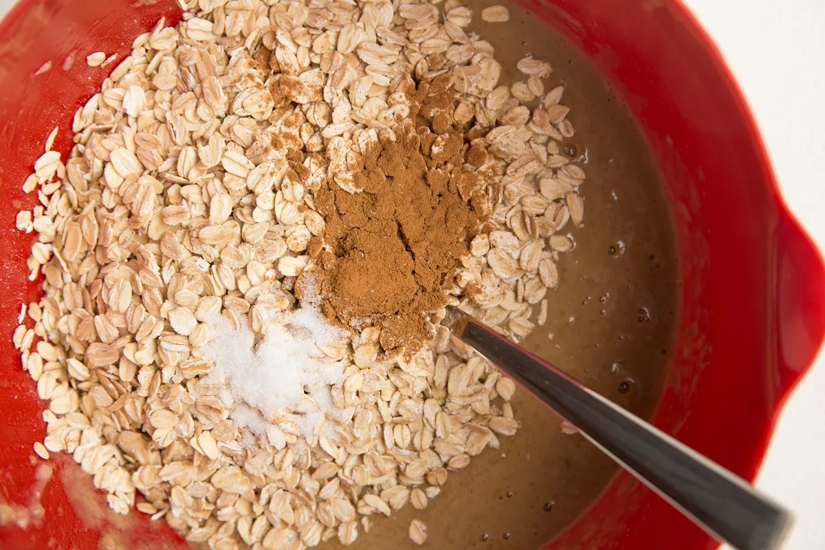 oats on top of wet mixture with cinnamon and salt