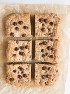 Cookie bars sliced into individual portions on a parchment paper