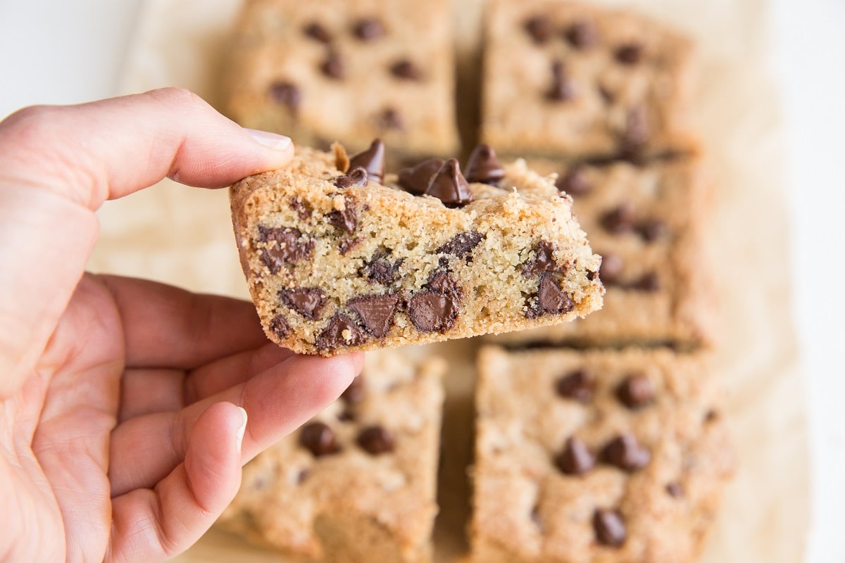 Hand holding a chocolate chip cookie bar