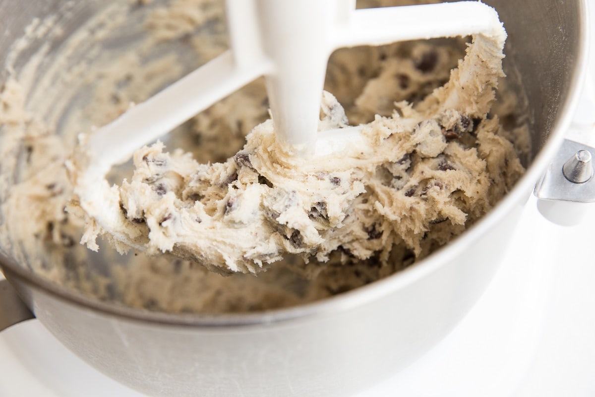 Chocolate chip cookie dough in a KitchenAid mixer