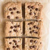 Cookie bars sliced into individual portions on a parchment paper