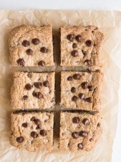 Cookie bars sliced into individual portions on a parchment paper