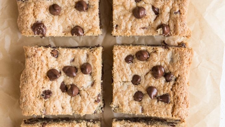 Cookie bars sliced into individual portions on a parchment paper