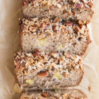 loaf of hummingbird bread on parchment paper, cut into slices