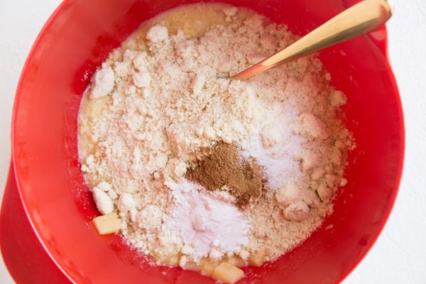 Dry ingredients on top of wet ingredients in a mixing bowl.