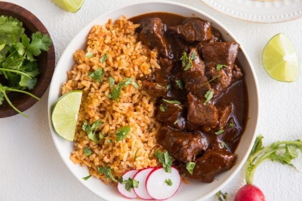 Horizontal top down photo of bowl of chile colorado with Spanish rice