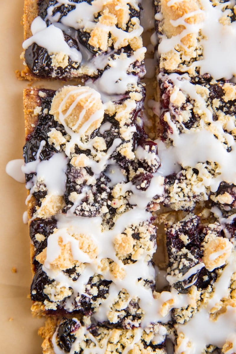 close up top down photo of cherry pie bars drizzled with glaze